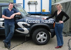 Neil Carter and Hermina Graham pose next to the BFBS Land Rover...