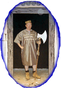 Wielding his large chopper, Robert as Evil Saladin's aide Onion Bhaji